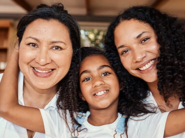 Photo of two women and a young girl.